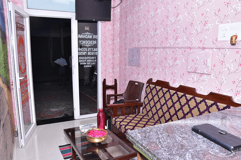 Comfortable twin beds setup in a guest room at Sri Madhava Residency